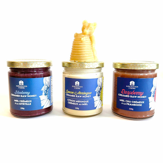 blueberry, lemon and raspberry creamed hone with a bear shaped beeswax candle
