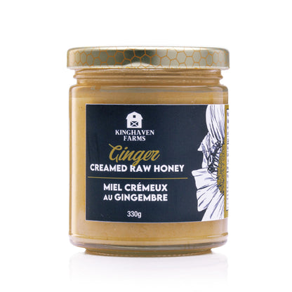 Jar of Kinghaven Farms ginger creamed raw honey on a white background